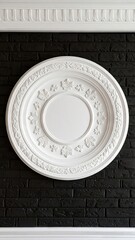 Whitewashed Plaster Ceiling Medallion Against Black Brick Wall Showing Detailed Circular Relief Pattern and Decorative Elements