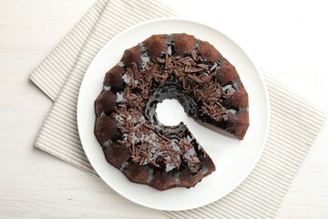 Delicious chocolate bundt cake on light wooden table, top view