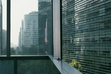Glass structures and facade patterns in a financial district define modern urban architecture, geometric forms, reflections and architectural details emphasizing urban minimalism and corporate design.