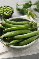 Fresh ripe green peas on grey table, closeup