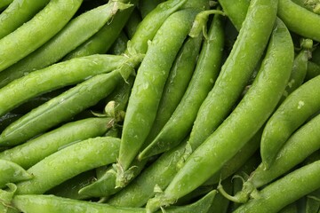 Fresh green pea pods as background, top view