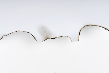 White burnt paper. burnt paper edges close up. abstract. split background