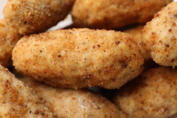 Tasty fried croquettes as background, closeup view