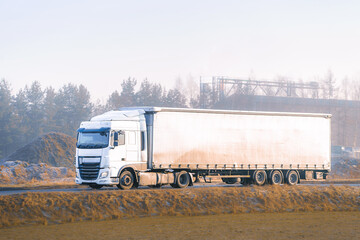 Shiny white cargo truck in countryside