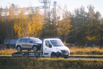 Car being towed by transport truck