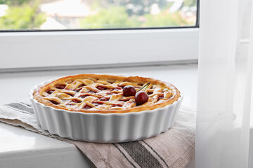 Tasty cherry pie on windowsill indoors, closeup