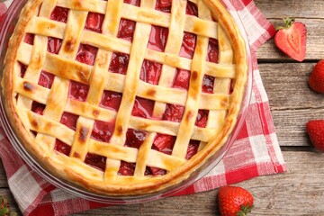 Tasty strawberry pie and berries on wooden table, flat lay