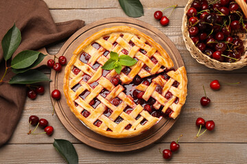 Tasty cut cherry pie and berries on wooden table, flat lay