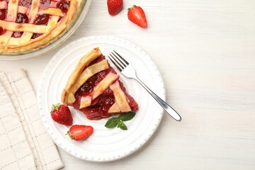 Piece of tasty strawberry pie and berries on white wooden table, flat lay. Space for text