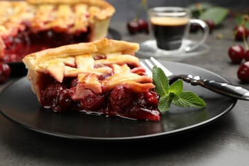 Piece of tasty cherry pie and berries on grey table, closeup