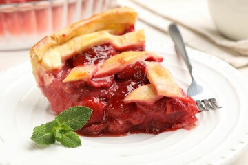 Piece of tasty strawberries pie on table, closeup