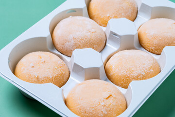 Japanese Mango ice cream mochi on green background