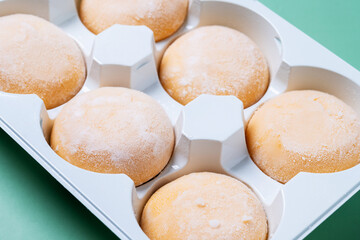 Japanese Mango ice cream mochi on green background