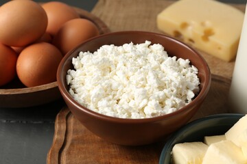 Different dairy products and eggs on grey wooden table, closeup