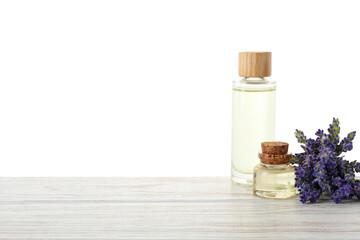 Natural essential oil and lavender flowers on wooden table against white background