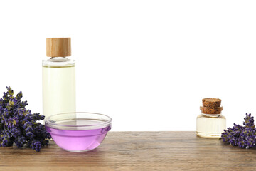 Natural essential oil and lavender flowers on wooden table against white background