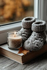 Autumn relaxation theme with cozy socks, candle, book, and maple leaf on windowsill, evoking warmth and comfort for seasonal marketing or lifestyle promotions