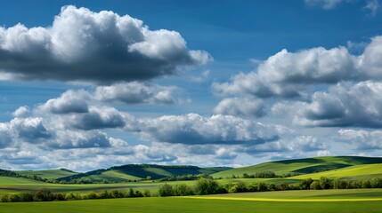 Puffy fair weather cumulus cloud floating over rolling hill farmland during springtime vibrant green soft shadow peaceful rural landscape under dynamic sky custom bright countryside panorama