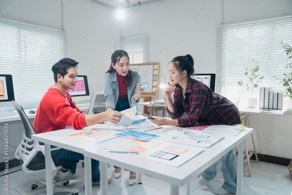 Poster three ui ux designers are working together on a mobile app interface wireframe design in a modern of