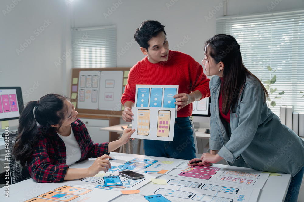 Poster creative team discussing mobile app interface design, analyzing wireframes and prototypes. diverse g