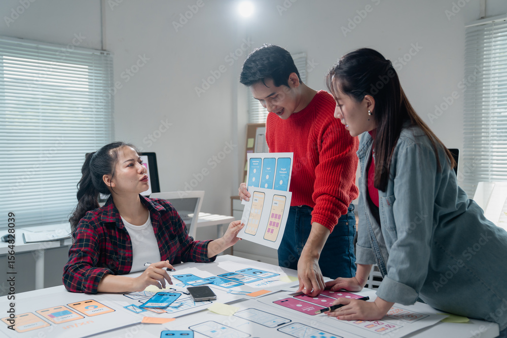 Poster group of young professionals engaged in a collaborative brainstorming session for mobile app design,
