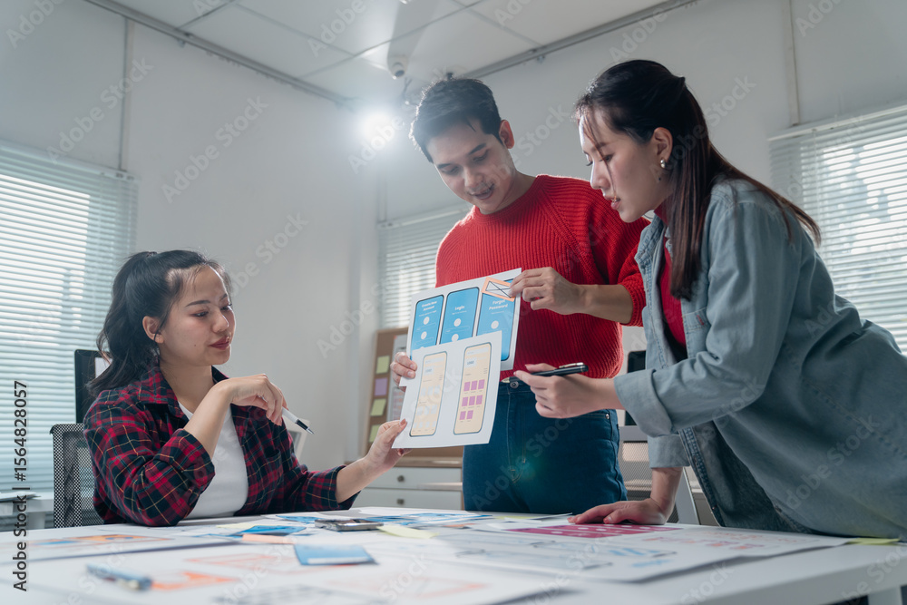 Poster three asian user experience designers are collaborating on a new mobile app interface wireframe desi