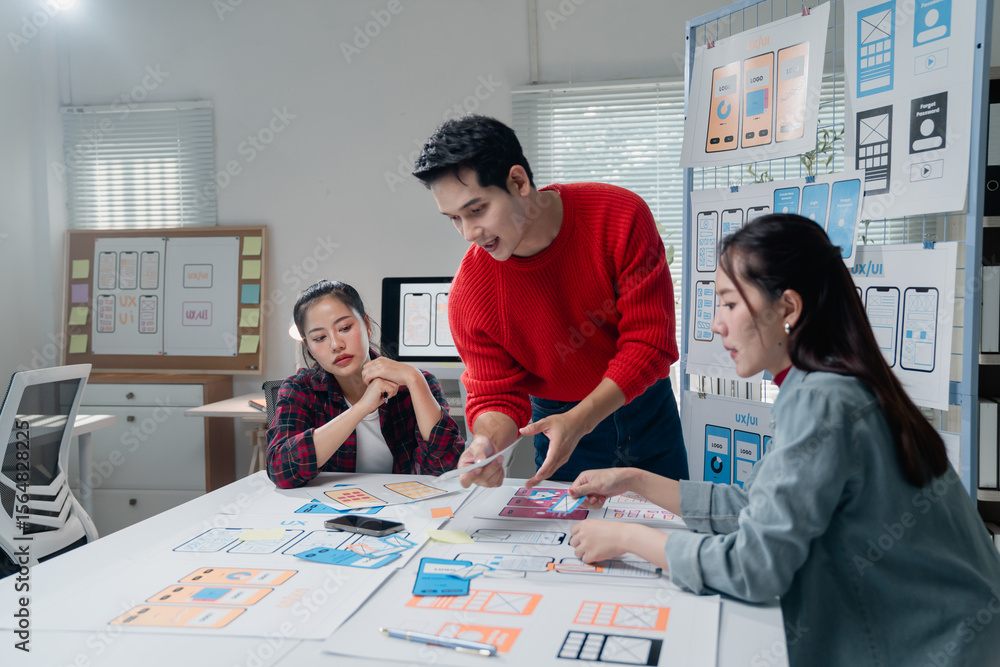 Poster diverse group of designers working together on a mobile app project, discussing layouts and wirefram