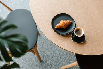Delicious and elegant breakfast of a croissant and a coffee