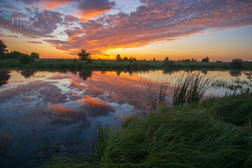 awesome summer sunrise over the lake and meadows