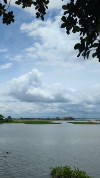 Busy River Scene with Cargo Boats and Local Activity | Monsoon Season in Bangladesh
