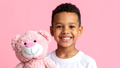 Cheerful child holding pink plush toy against pink background, radiating joy and innocence