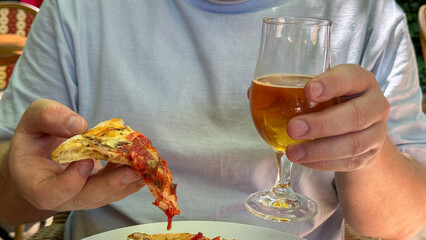 A jovial afternoon, savoring tangy pizza and amber ale, perfect for Oktoberfest's hearty spirit and International Beer Day revelry