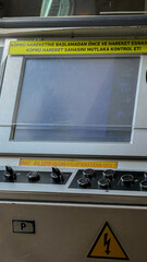 Steel console pulses with enigmatic whispers, cautionary tales in Turkish script beckoning...