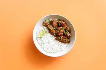 Chicken wings in teriyaki sauce with rice, sesame and onion. Asian food.