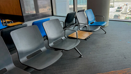 Silent airport chairs patiently await wayward travelers, whispering tales of wanderlust and serendipitous layovers, evoking Travel Trivia Day