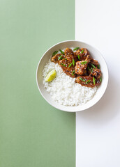 Chicken wings in teriyaki sauce with rice, sesame and onion. Asian food.