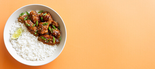 Chicken wings in teriyaki sauce with rice, sesame and onion. Asian food.