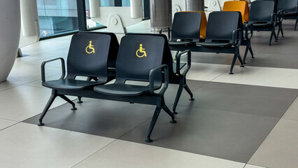 Reserved for universal accessibility, airport chairs whisper tranquility, echoing Equality Day and International Day of Persons with Disabilities