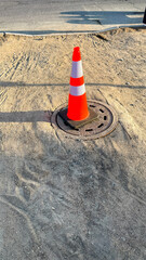 Neon cone guarding the shadowy manhole, urban sentinel of underground mysteries, celebrating...