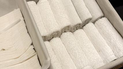 Pristine rolled towels in serene spa sanctuary, echoing minimalism and Zen aesthetics, perfect for Global Wellness Day serenity