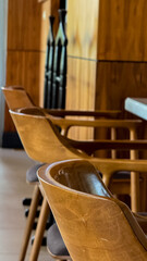 Polished oak chairs bask in midday glow, echoing whispers of hygge gatherings and rustic serenity...