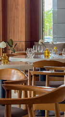 Ambient wooden cafe tables beckon intimate gatherings, echoing Earth Day serenity and World Design Day's elegance with minimalist decor