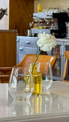 Glass duo cradles ethereal bloom, anointing charming cafe backdrop, murmuring tales of Secret...