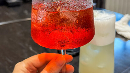 Effervescent crimson cocktail glistening with icy splendor, toasting La Tomatina or Venetian spritz...