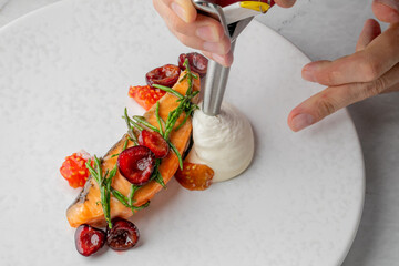 Salmon adorned with cherry jewels and rosemary, paired with whipped delight, evokes Midsummer...