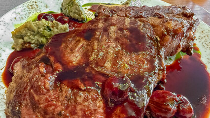 Juicy rib-eye steak drenched in tangy cherry glaze epitomizes indulgence, perfect for National Meat...