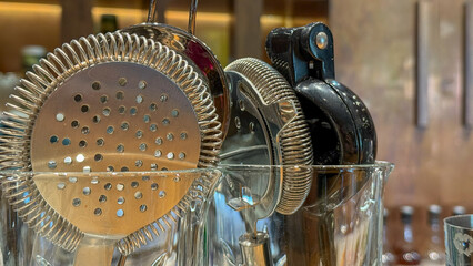 Shimmering bar tools poised like metallic guardians, cocktail craftsmanship, World Bartender Day,...