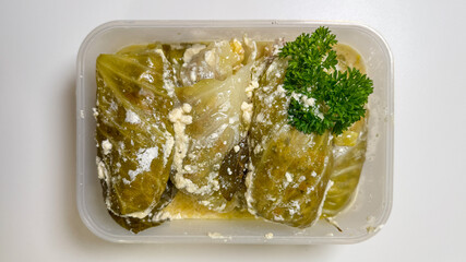 Savory cabbage rolls embrace creamy feta, celebrating Balkan gastronomy and International Cabbage...