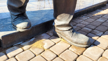 Close-Up of Human Sculpture Feet and Shoes, Capturing Intricate Details and Artistic Expression.