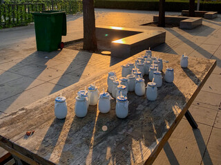 Ceramic milk jars bask in golden sunset, echoing rustic artisan markets and celebrating National...